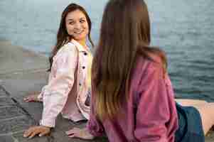 Free photo smiley female friends by the lake