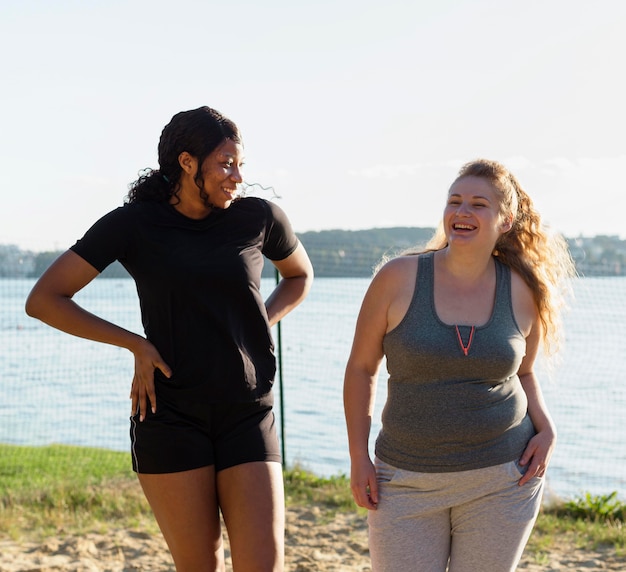 Smiley female friends posing together after working out