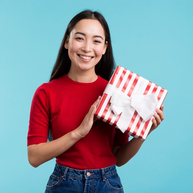 Smiley female holding gift box