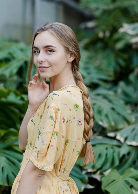 Smiley female posing in greenhouse