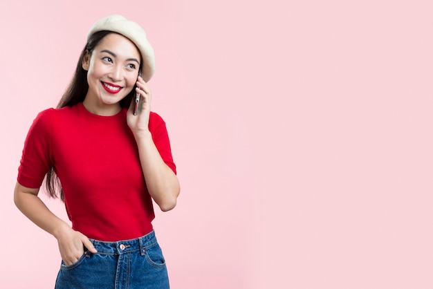 Smiley female talking over phone