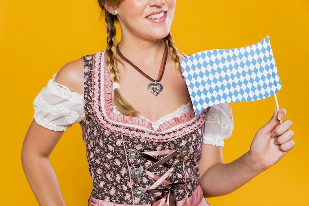 Free photo smiley festive girl holding flag