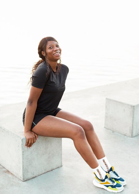 Smiley fit woman posing outside