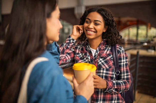 Free photo smiley friends conversing over coffee