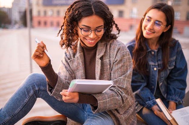 Smiley friends doing homework outside