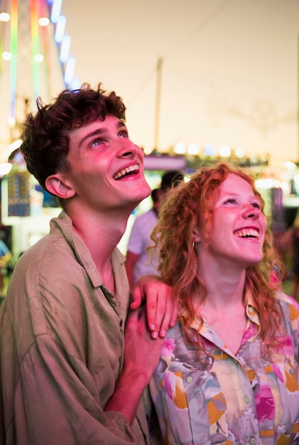 Free photo smiley friends enjoying funfair together