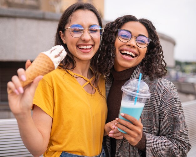 Smiley friends having fun together with milkshakes