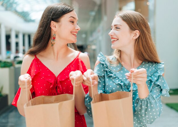 Smiley friends holding their shopping bags