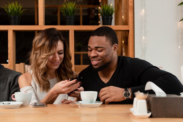 smiley friends looking on mobile