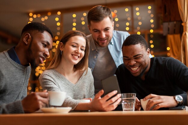 Smiley friends at restaurant taking photos