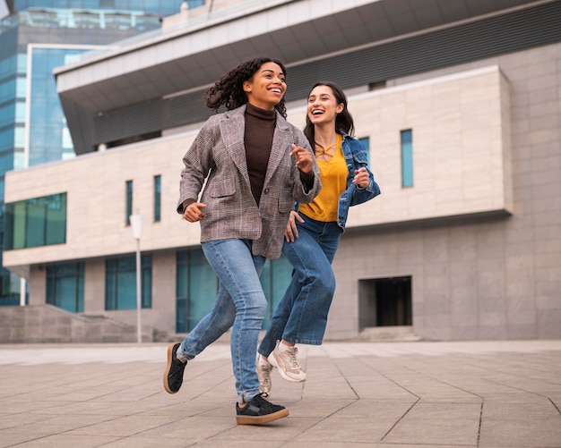 Smiley friends running together outdoors