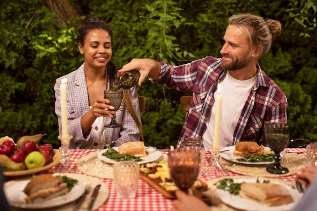 Free photo smiley friends sitting at table medium shot