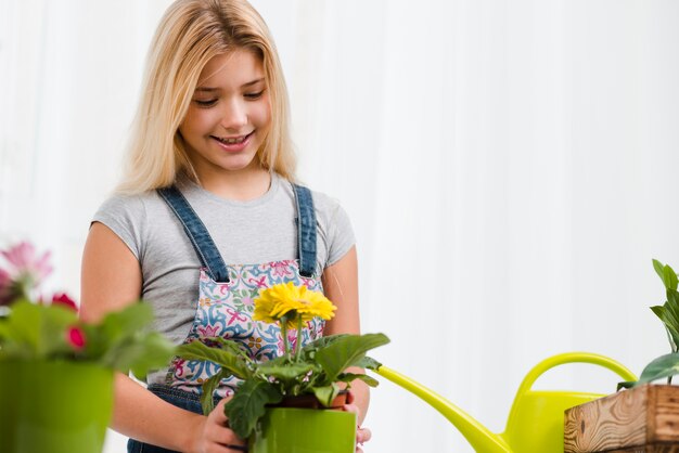 Smiley girl in greenhouse