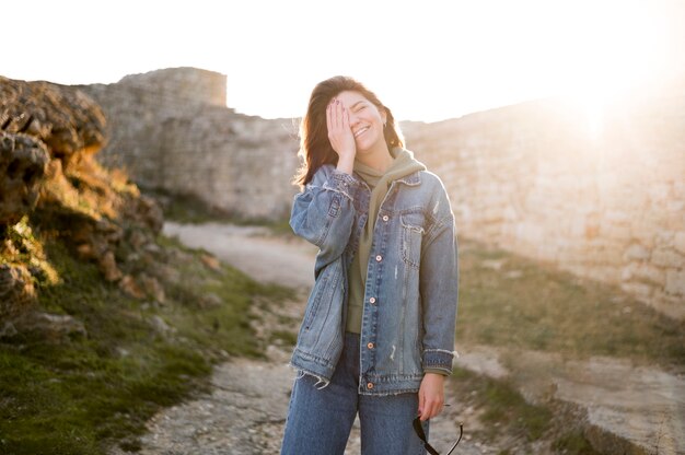 Smiley girl hiding her face with hand