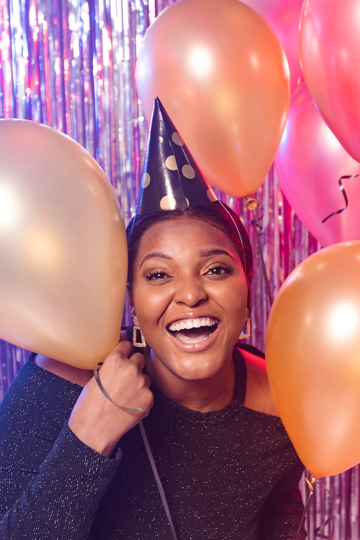 Free Photo smiley girl holding balloons front view