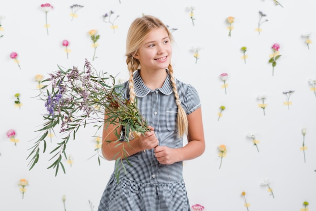 Smiley girl holding bouquet of flowers