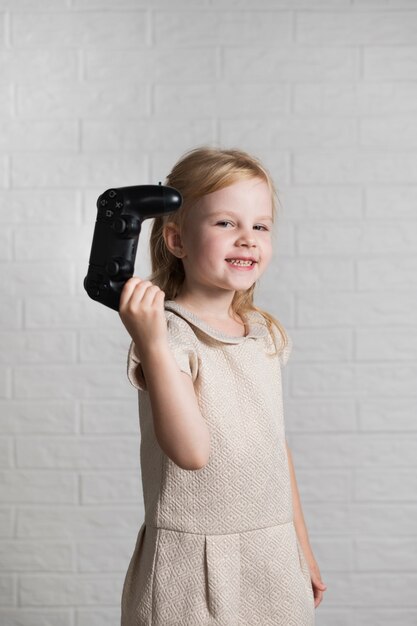 Free photo smiley girl showing for camera joystick