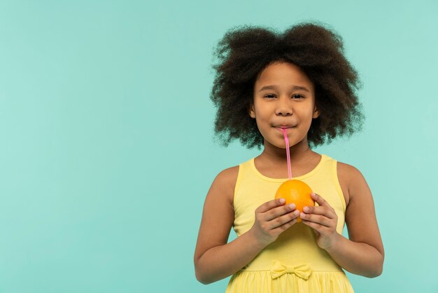 Smiley girl in a summer setting studio