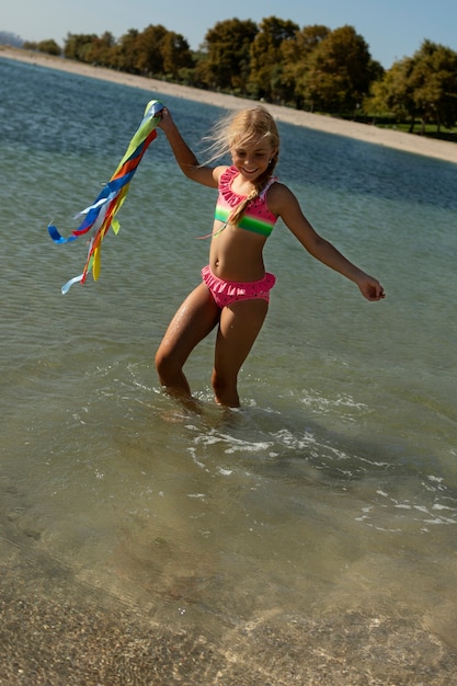 smiley girl in water full shot
