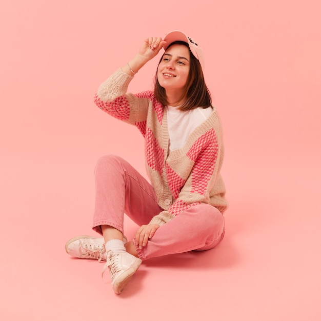 Smiley girl with cap sitting