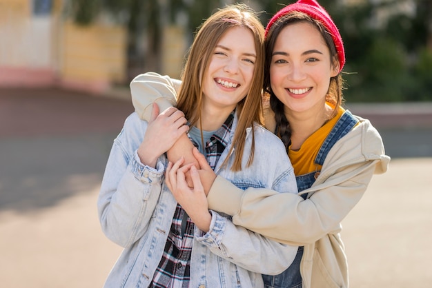 Smiley girlfriends hug