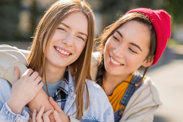 Smiley girlfriends hugging