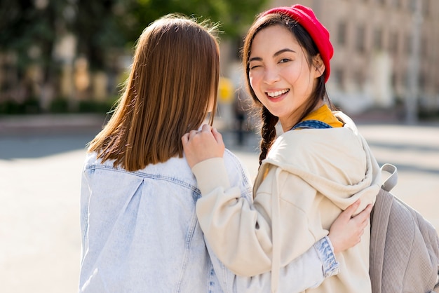 Free photo smiley girlfriends walking