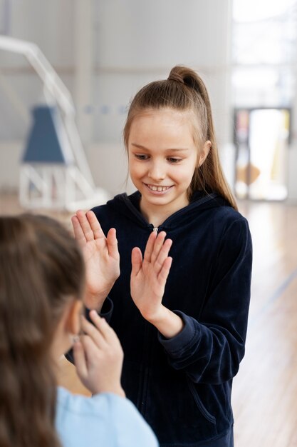 Smiley girls playing game at gym