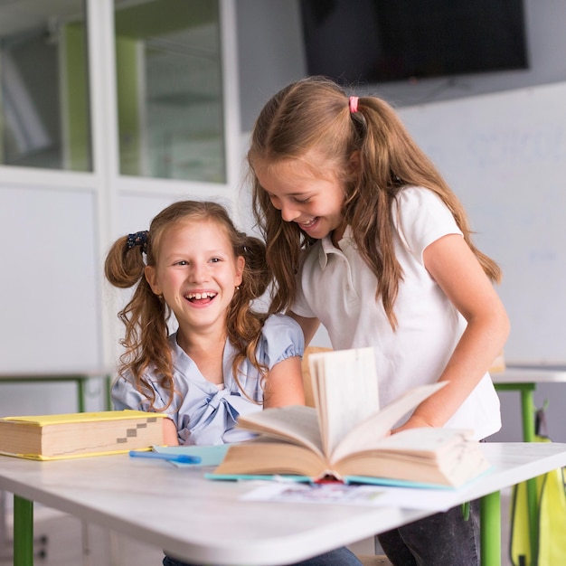 Smiley girls talking in class