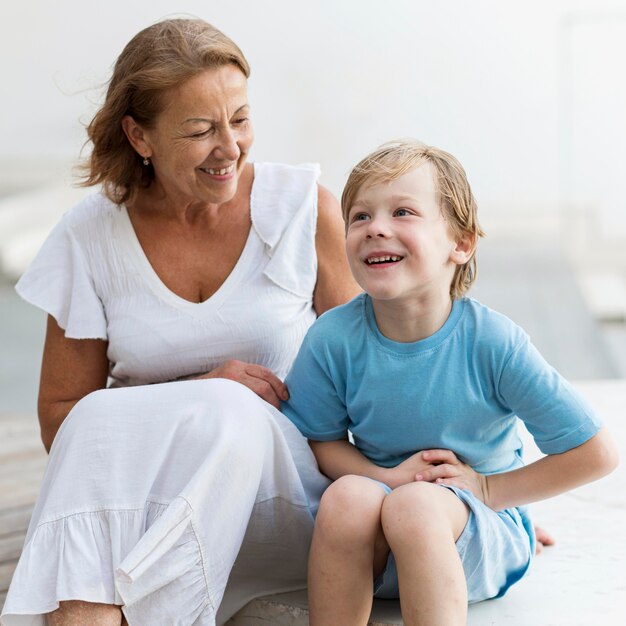 Smiley grandma and kid sitting