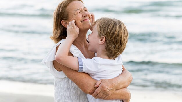 Smiley grandmother holding child