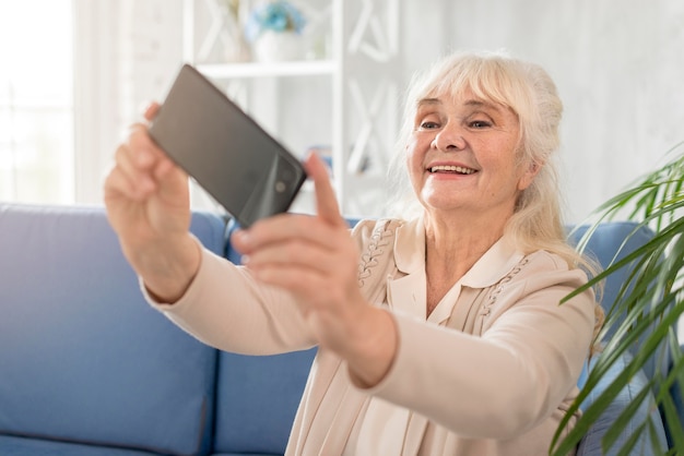 Smiley grandmother taking selfie