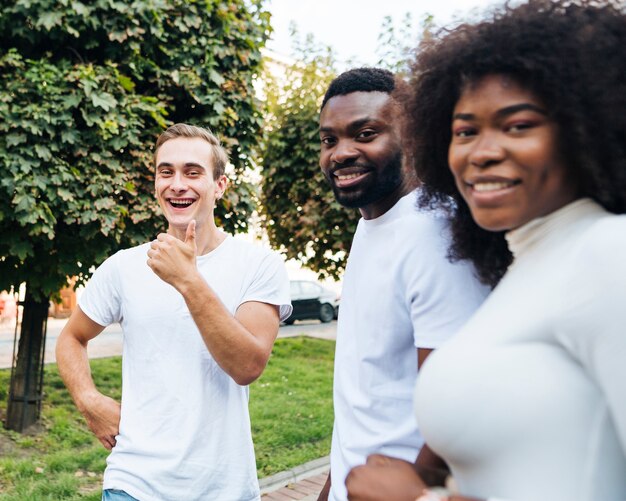 Smiley intercultural friends looking at camera