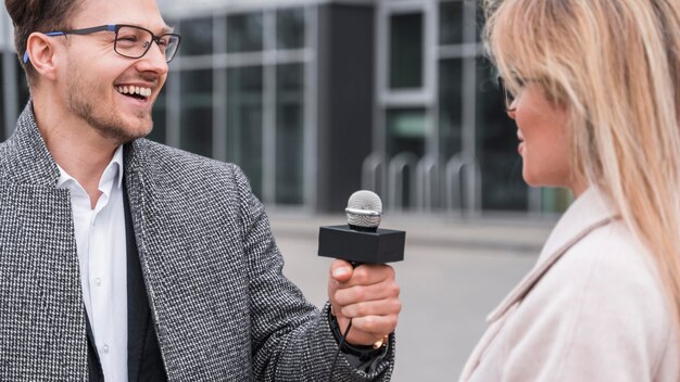 Smiley journalist doing interview