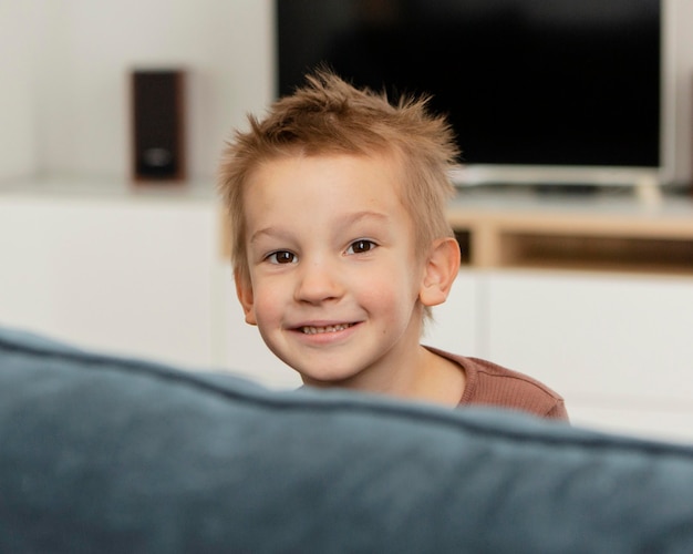 Smiley kid posing on the sofa