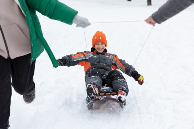 Smiley kid on sleigh winter time