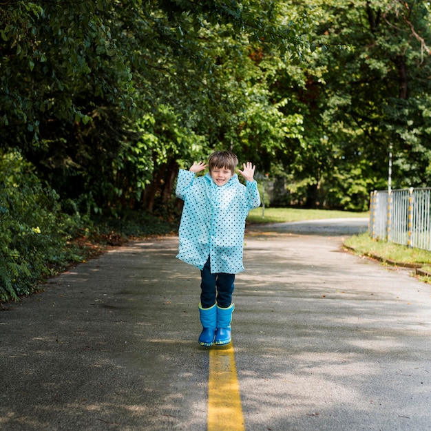 Free photo smiley kid wearing a rain coat