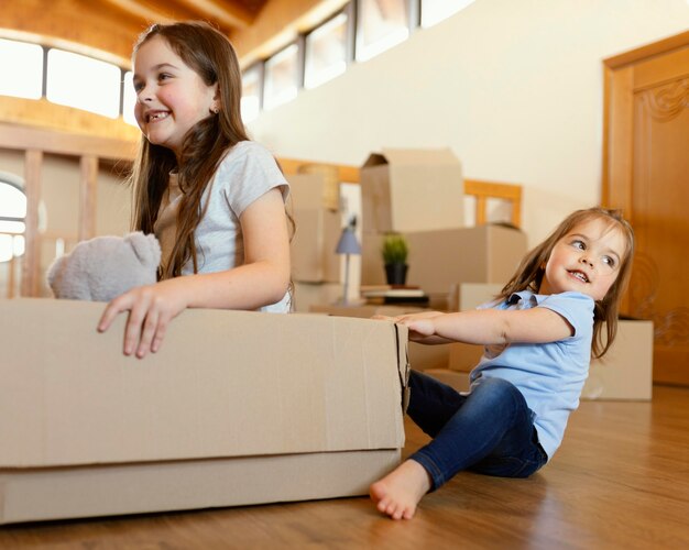 Smiley kids playing with box