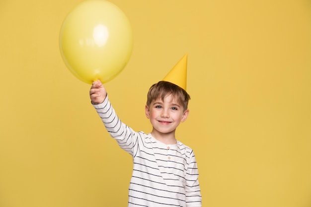 Smiley little boy isolated on yellow