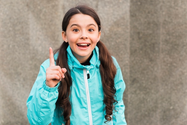 Free photo smiley little girl wearing sportswear