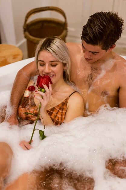 Smiley lovely couple taking a bath