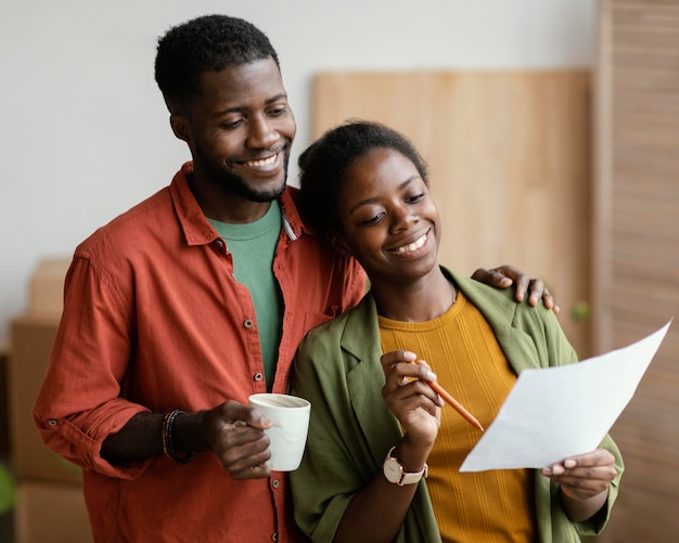 Smiley loving couple planning on redecorating home