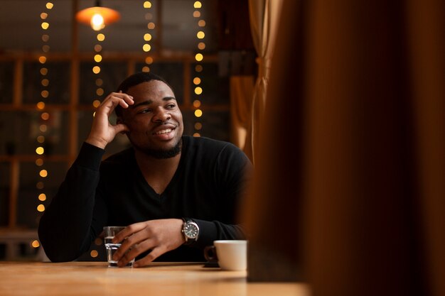 Smiley male enjoying cup of coffee