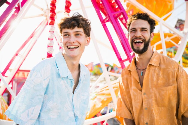 Smiley male friends in sunlight looking away