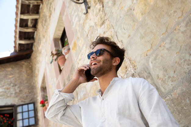 Smiley male traveler in white shirt portrait