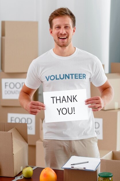Smiley male volunteer thanking you for donating food