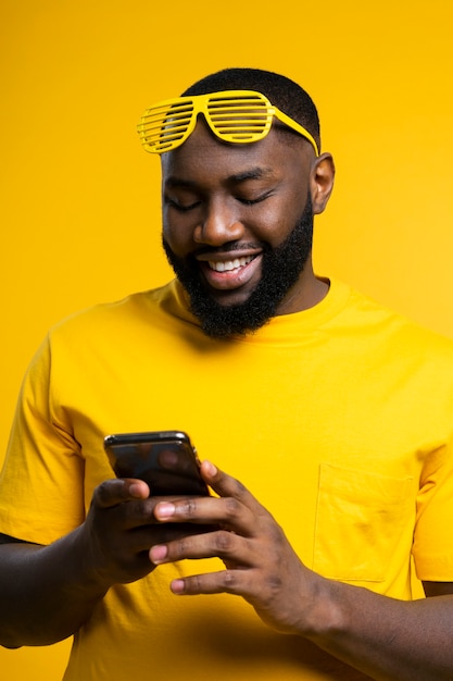 Foto gratuita uomo di smiley che controlla cellulare