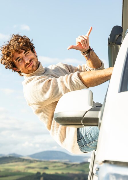 Smiley man enjoying a road trip