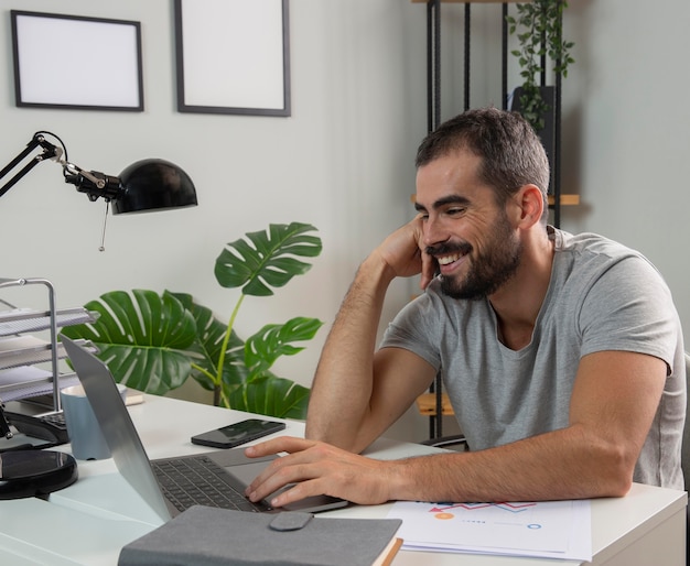 Smiley man enjoying working from home