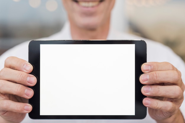 Smiley man holding an empty tablet